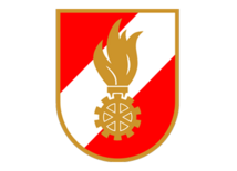 Das Feuerwehr-Logo zeigt ein rot-weißes Wappen mit goldener Flamme und Zahnrad. Es steht für Einsatzbereitschaft und Technik im Feuerwehrwesen.